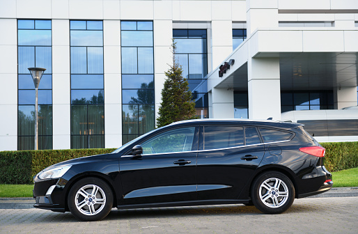 Belarus, Minsk -23.09.2022:A black 2019 Ford Focus wagon pulled up outside the hotel. The Focus is one of the most popular compact cars on
