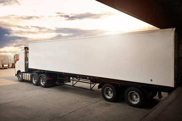 istock Semi Trailer Trucks Parked Loading at Dock Warehouse. Shipping Cargo Container Delivery Trucks. Distribution Warehouse. Freight Trucks Cargo Transport. Warehouse Logistics. 1428236063