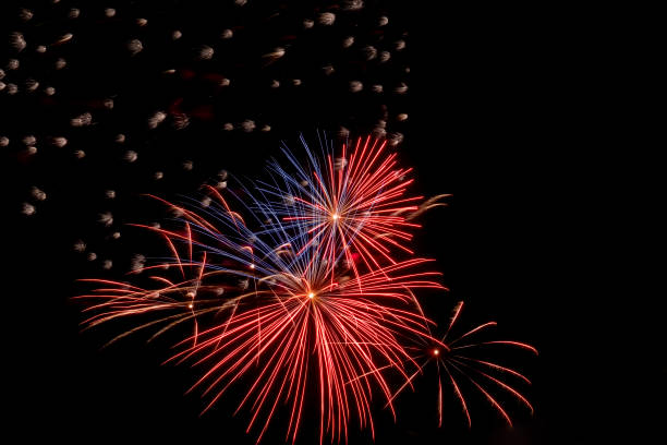 istock Festive fireworks. Bright beams of exploding pyrotechnics against black night sky. 1428236746