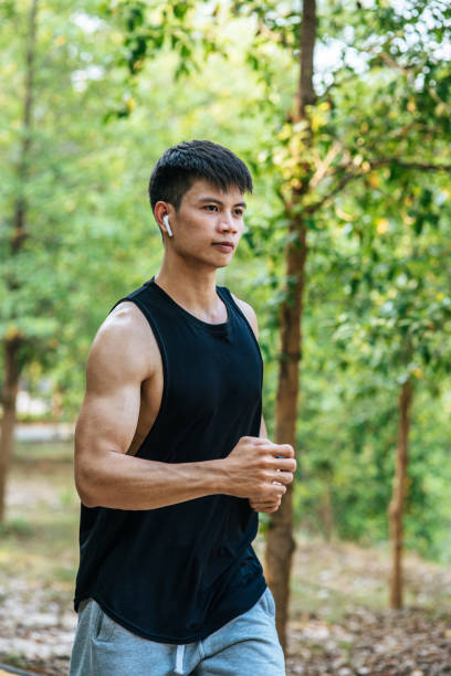 istock Men and women exercise by running on the road. 1428237301