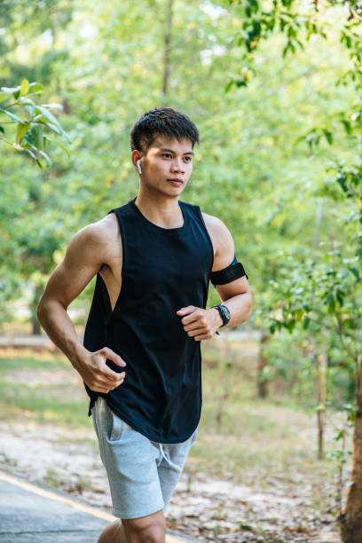 istock Men and women exercise by running on the road. 1428237302