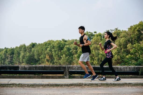 istock Men and women exercise by running. 1428237699