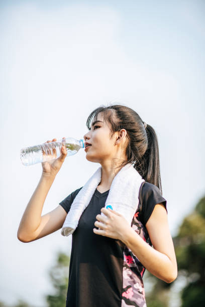 istock Women stand to drink water after exercise 1428238617
