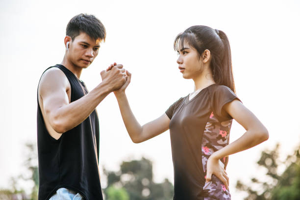istock Women and men stand holding hands to exercise. 1428238732
