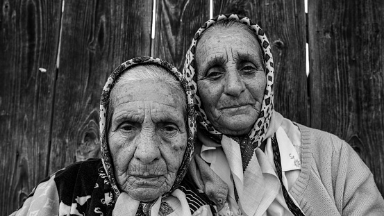 Humor, Bukovina, Romania - August 22, 2021: Friendship between old village Ladies in Romania