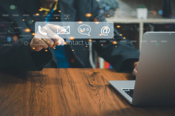 istock Businessman using a laptop and touching Contact us or Customer support hotline on virtual screen. 1428242892