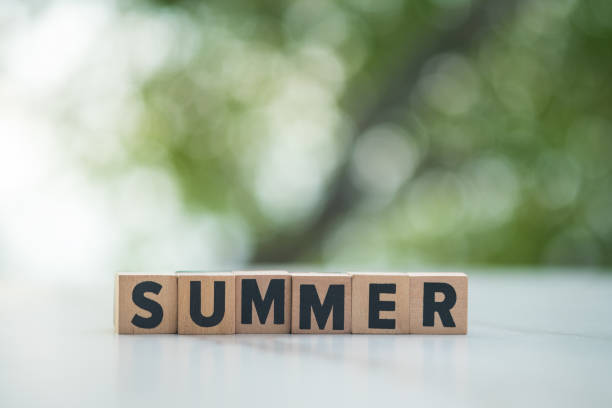 istock Wooden letters summer on table and against nature background 1428243567