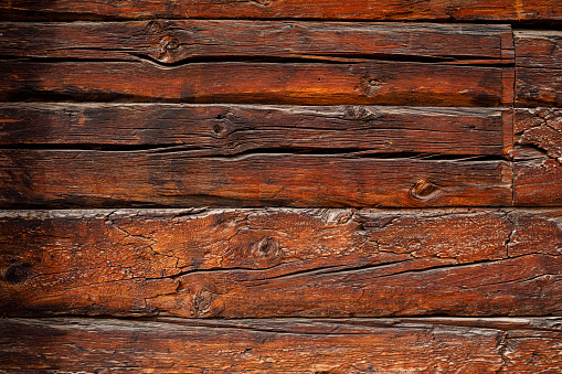 Old, gray, weathered wooden wall made of vertical boards in close-up 