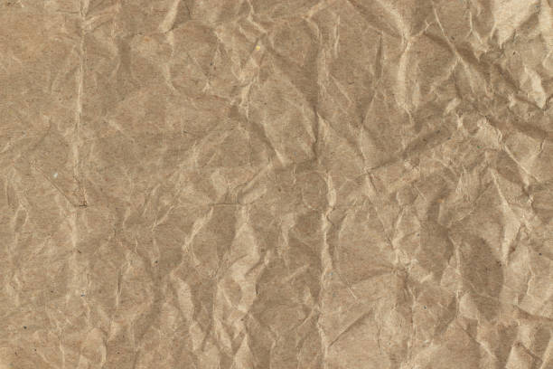 istock Brown crumpled kraft paper background. 1428246622