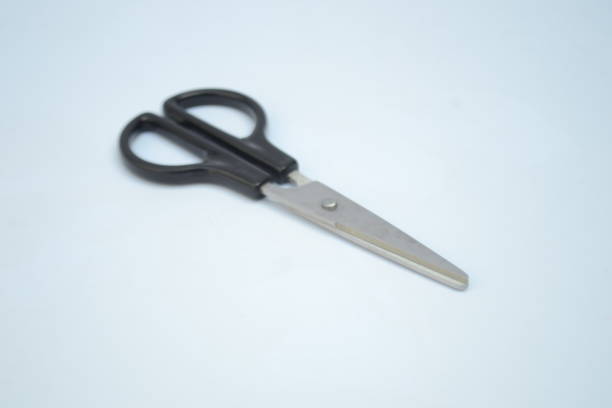 istock Silver scissor with black handle grip on isolated white background. Scissor is a household equipment that used to resize and reshape papers 1428247106
