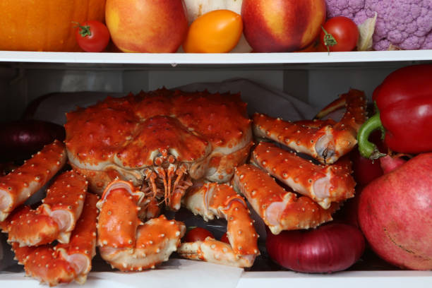 Kamchatka crab, seafood. Content of open refrigerator. Products for color diet. Organic fruits, vegetables Kamchatka crab, seafood. Refrigerator, content. Color diet. Organic food, fruits, vegetables. Rainbow food in fridge, refrigerator. Healthy, dietary nutrition. Multicolored nutrition for vegetarians, vegans. Products for diet rainbow crab stock pictures, royalty-free photos & images