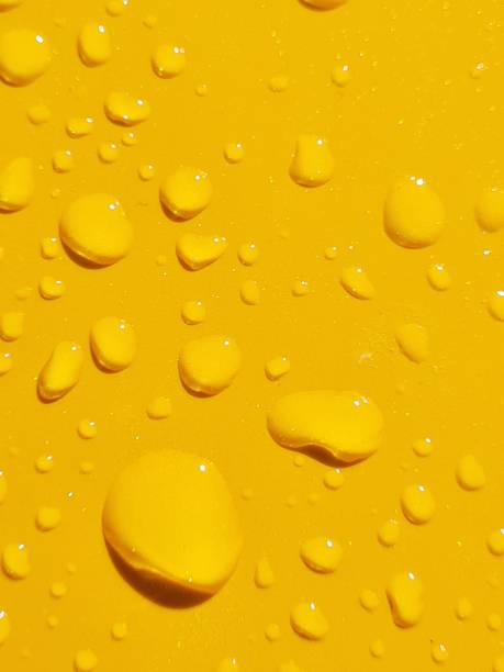 istock Raindrops on yellow car body 1428248909