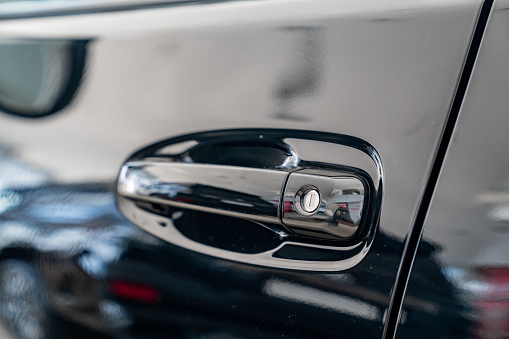 the handle on the door on the black car. purchase and sale of modern cars in official dealerships and auto shops. sale of auto parts. maintenance.