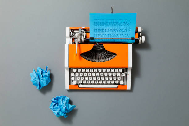 istock Orange 70s Typewriter with blue Paper 1428252268