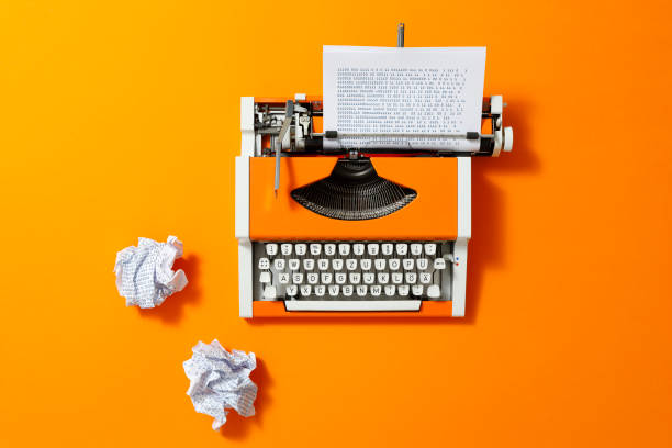 istock Orange 70s Typewriter with blue Paper 1428252281
