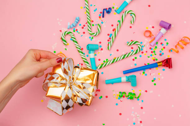 istock gift box with various party confetti, streamers and decoration 1428254344