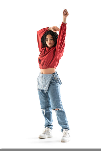 istock Latin brunette woman dancing in studio with white background 1428258265