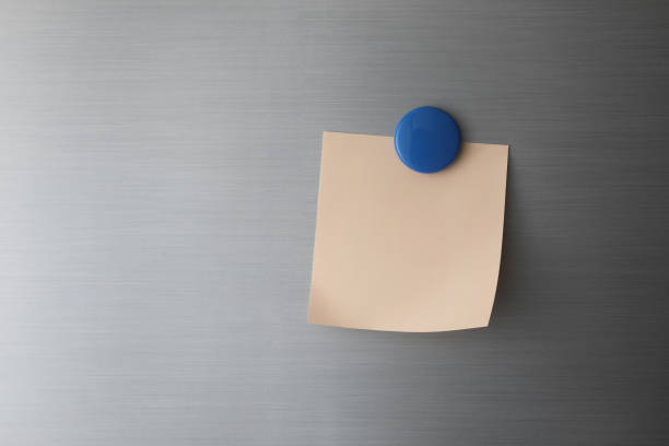 istock Blank paper on fridge door with blue magnet 1428259781