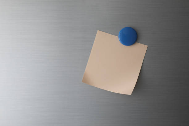 istock Blank paper on fridge door with blue magnet 1428259838