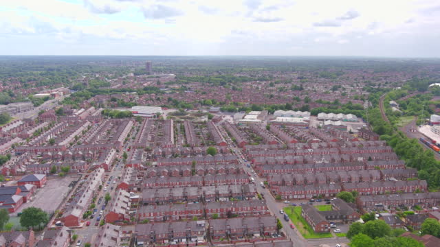 Manchester, UK: Aerial view of city in England, suburb with greenery - landscape panorama of United Kingdom from above