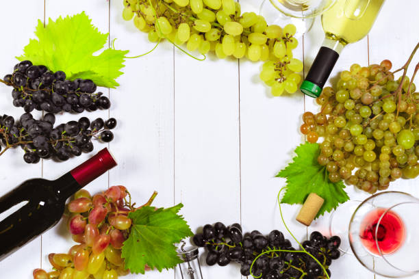 istock wine with branches of white grapes. On a wooden table. 1428260843