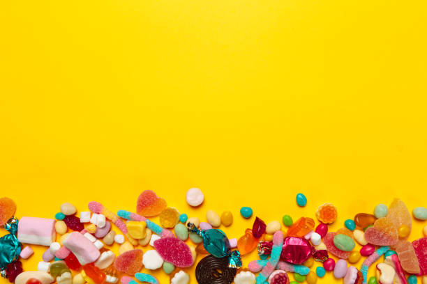 istock colored candies on yellow background 1428262484