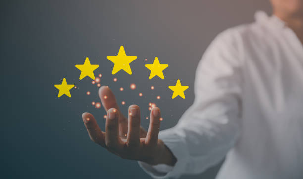 Business are holding five stars, raising their rank or raising the highest ratings, best assessment and ranking idea. Customer service and Satisfaction concept, rating very impressed. stock photo