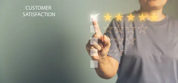 Photo of Customer service feedback. Business person are touching the virtual screen on happy Smiley face icon to give satisfaction in service. Customer service and Satisfaction concept, rating very impressed.