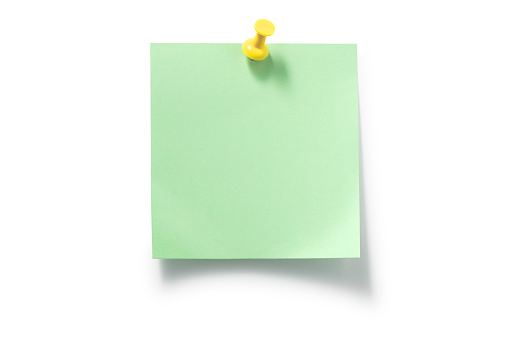 yellow pushpin and green sticky notes on white backgroun.