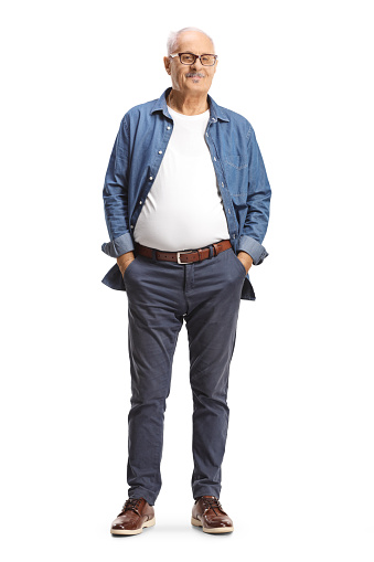 Full length portrait of a mature man with glasses posing with hands in pockets isolated on white background