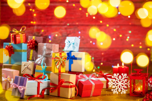 istock Many gift box stacked as a Christmas gift boxes arrangement on red glitter background 1428265114