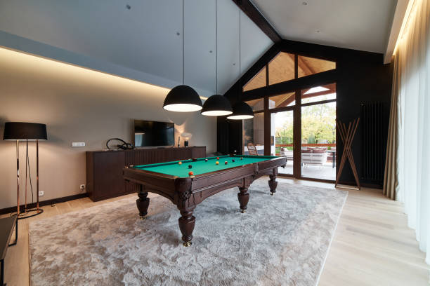 modern billiard room with a beautiful table and large windows