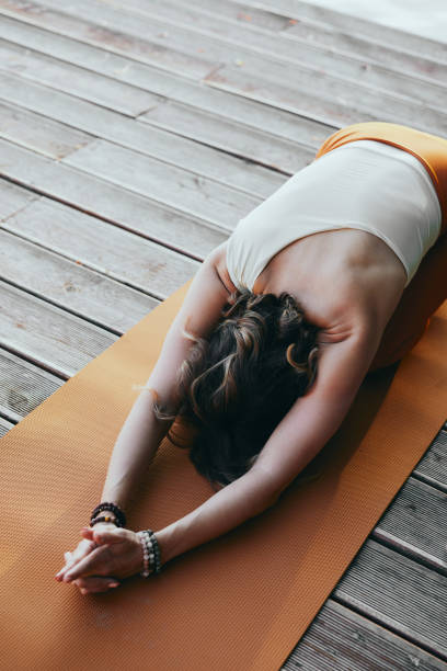 istock A woman practices yoga on the dock. 1428269886