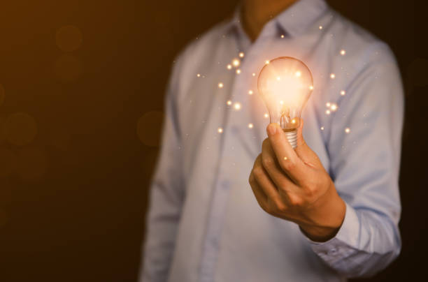 istock businessman holding a light bulb graphic Digital technology abstract. imagine an idea Creative and innovative. brain to brainstorm ideas in business. Strategies for development, growth, and success 1428270097