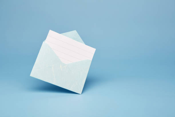 istock Bright blue office envelope with lined sheet on the blue background 1428270217