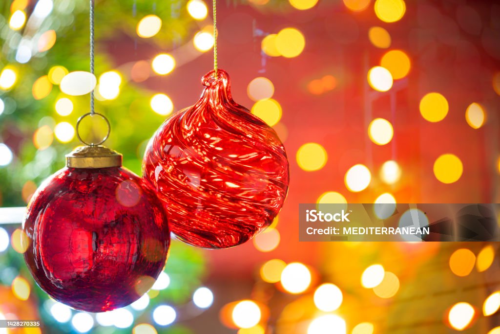 Christmas fir tree background with baubles and glowing Christmas Christmas fir tree background with baubles and glowing Christmas lights bokeh Christmas Ornament Stock Photo