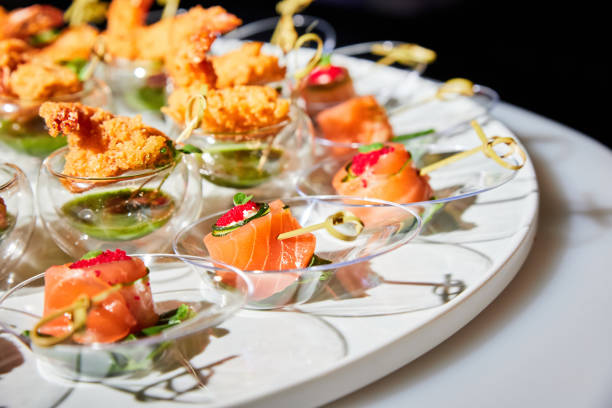 set of various small appetizers on a buffet table - restaurant banquet table wedding reception imagens e fotografias de stock