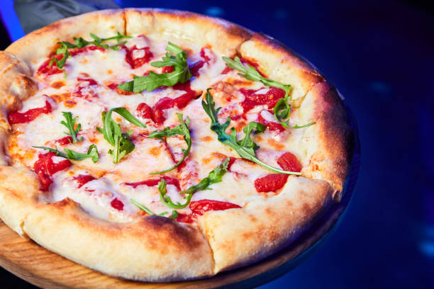 istock Pizza with cheese, tomatoes and arugula 1428270659