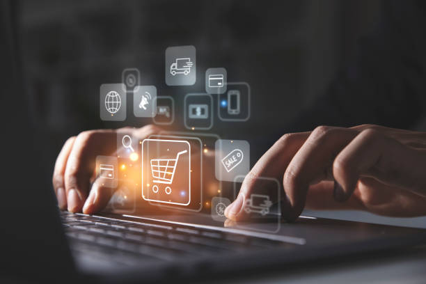 istock Young man using laptop with shopping cart icon. 1428271936