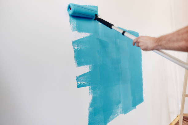 istock Painting the wall in blue! 1428273688