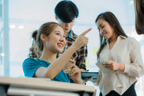 istock Asian creative teams sit and work together to share inspirational creativity in a workshop. Young modern businessmen are meeting with graph paper and laptop in the workplace. 1428273710