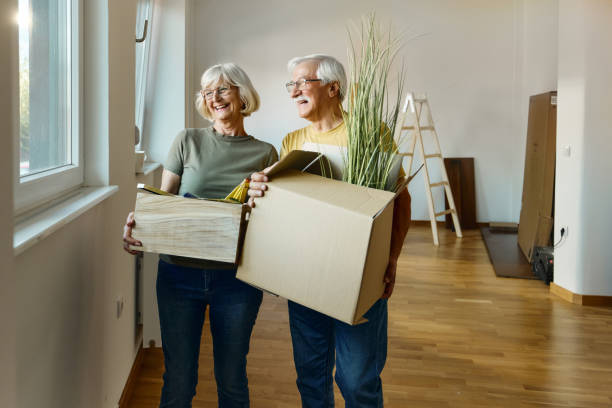 Happy senior couple moving into a new home. stock photo