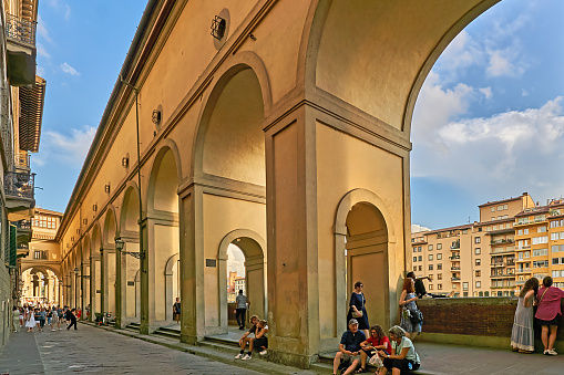 Florence, Italy - September 07, 2022: Pedestrians in Lungarno degli Archibusieri street near Ponte Vecchio and Uffizi Gallery.