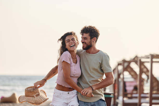 istock Young carefree couple having fun on the beach. 1428274921