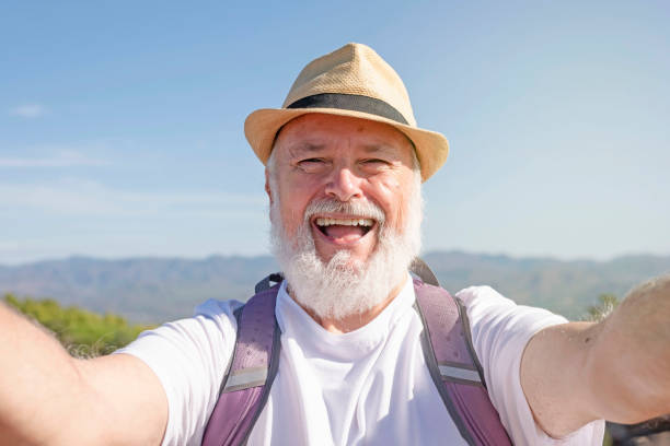 istock Handsome retired hiker taking selfie portrait using his smartphone 1428276231