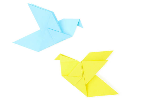 Red paper crane origami isolated on a blank white background.