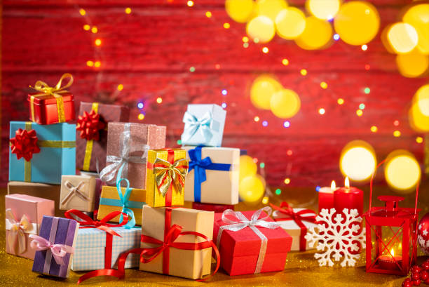 istock Many gift box stacked as a Christmas gift boxes arrangement on red glitter background 1428277235