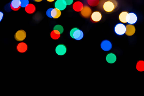 istock Clorful blurred lighs bokeh on black background as a festive backdrop 1428278560