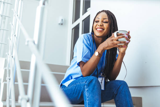 istock Female doctor sitting with mobile phone and drinking coffee 1428280056