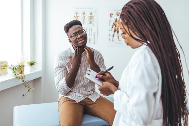 istock Discussing a sore throat at a doctor's appointment. 1428280245